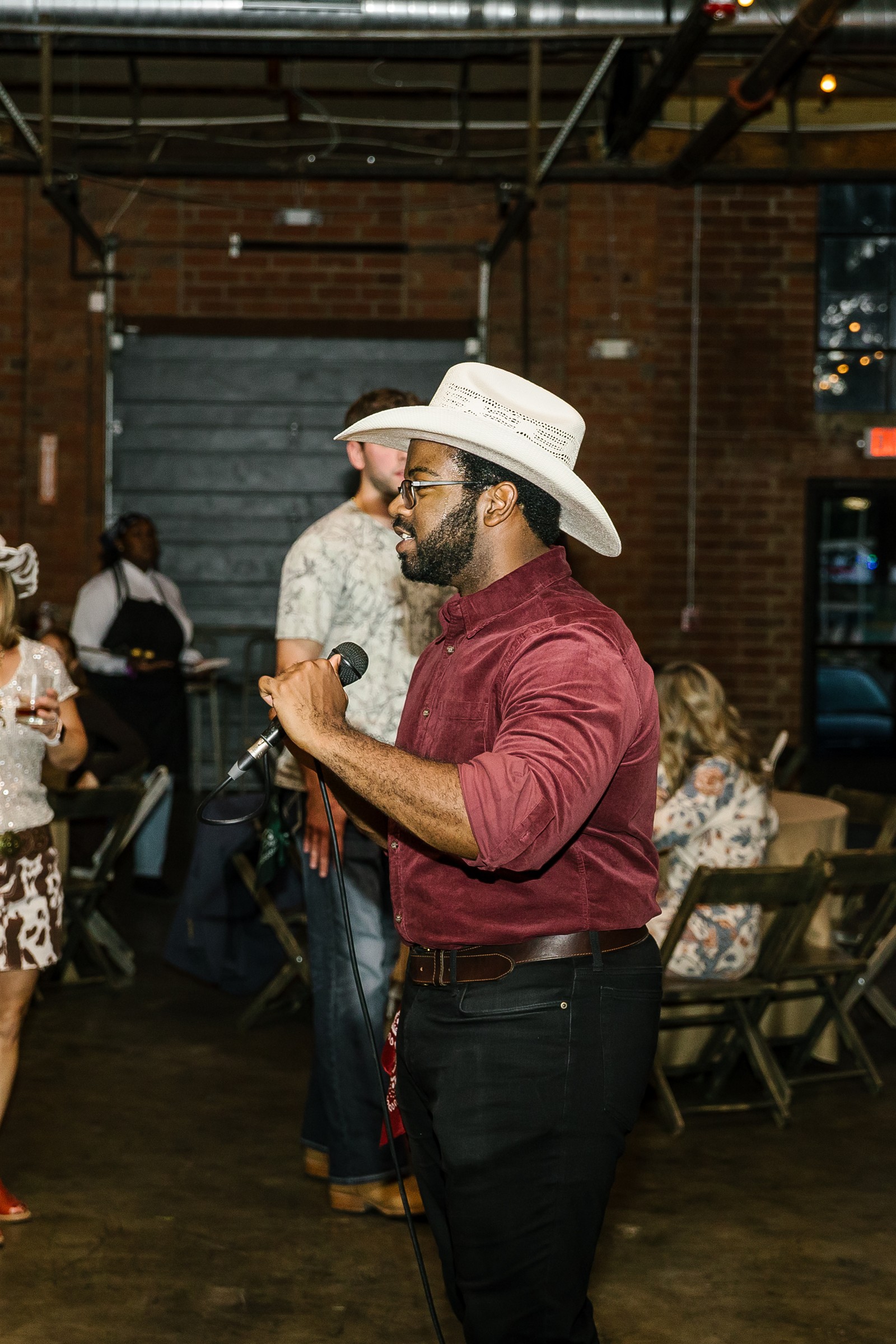 C.J. teaching with a microphone at a private event